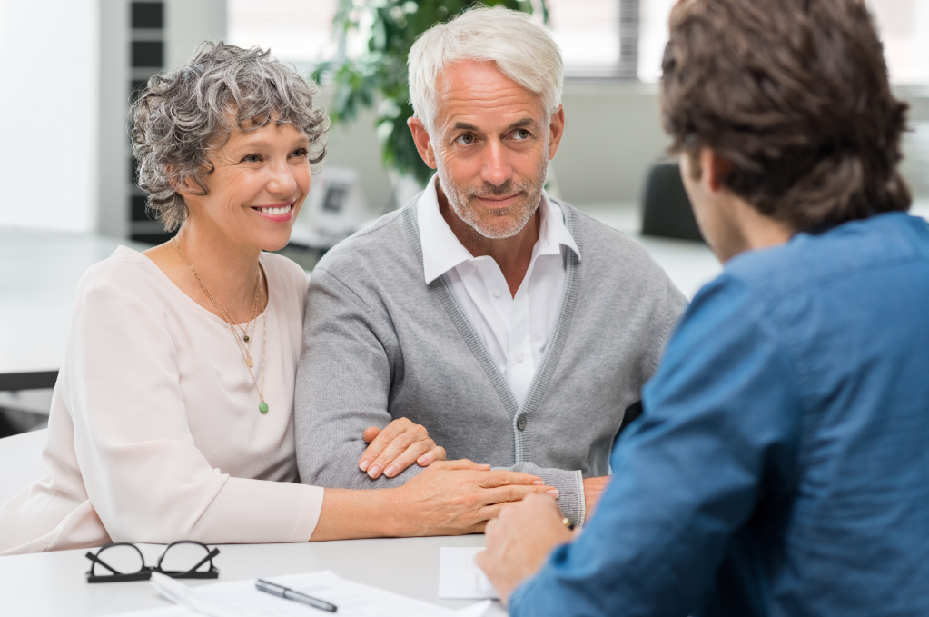 Senior couple meeting real estate agent. Senior couple meeting financial advisor for investment. Happy mature man and woman listening to various investment plans for their retirement