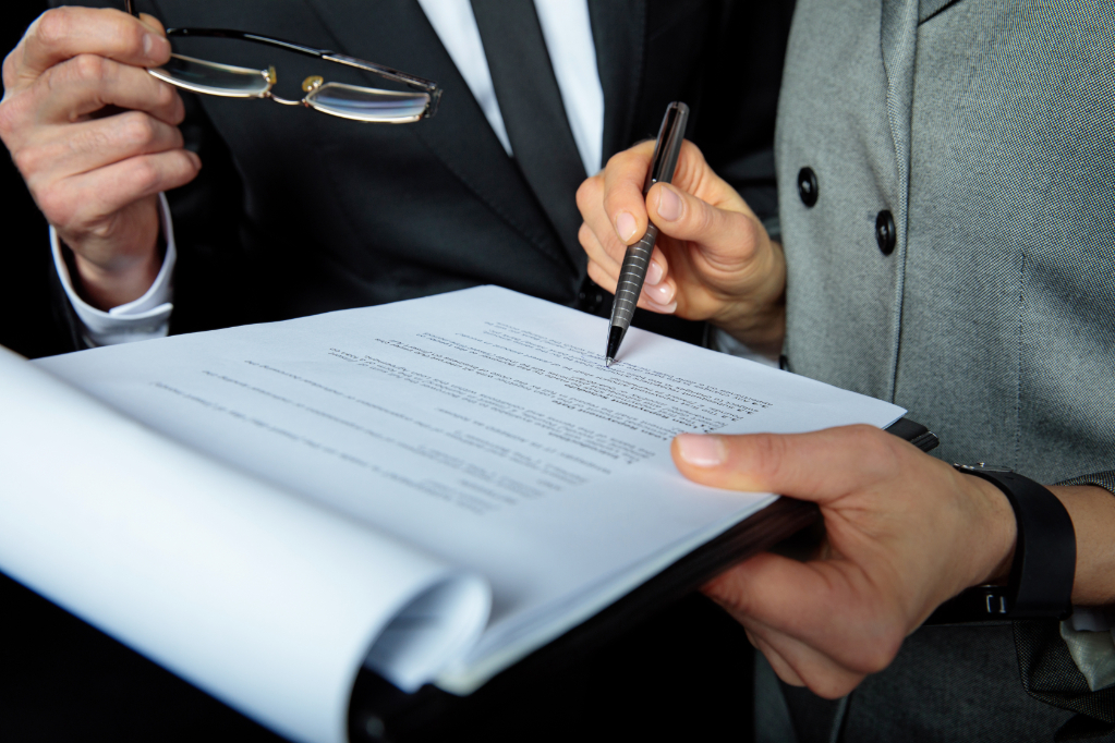 Two businesspeople signing papers