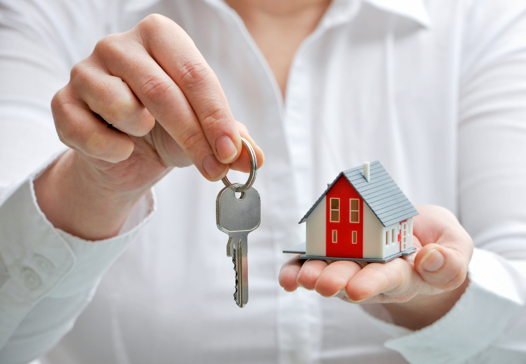 Real estate agent with house model and keys