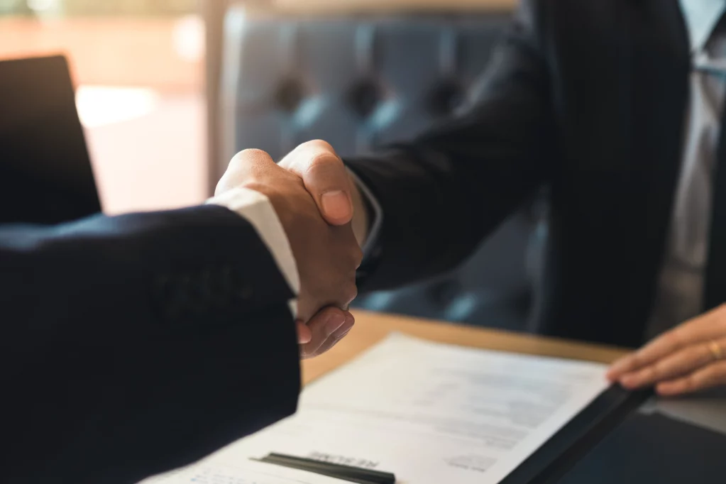 Business people shake hands over contract